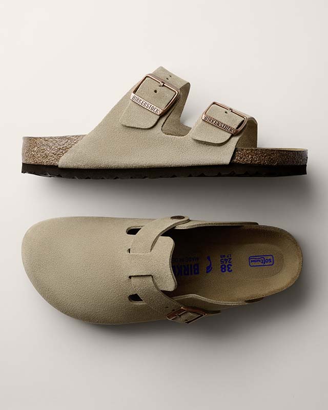 Two beige Birkenstock sandals, one with straps and one closed-toe, displayed against a neutral background.