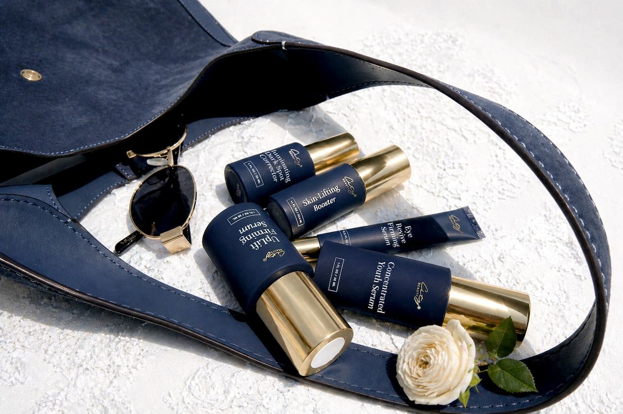 Mother's Day Weekend sale: enjoy 30% off high-impacts serums for all skin types. Pictured: a collection of serums arranged on a white blanket,