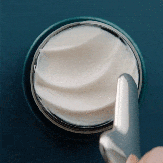 Rejuvenating Eye Tool scooping cream from the Rejuvenating Eye Cream jar.