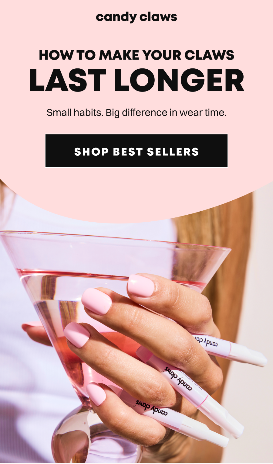 Hand holding pink nail glue bottles with glass reflection showing long pink nails