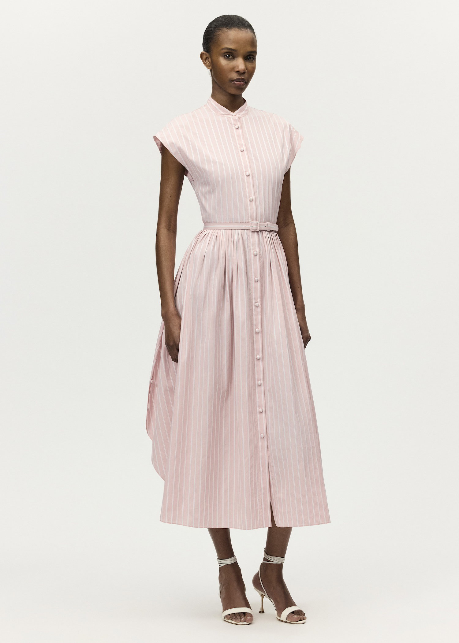 Image of a model wearing the Genevieve dress in pale pink and white stripes