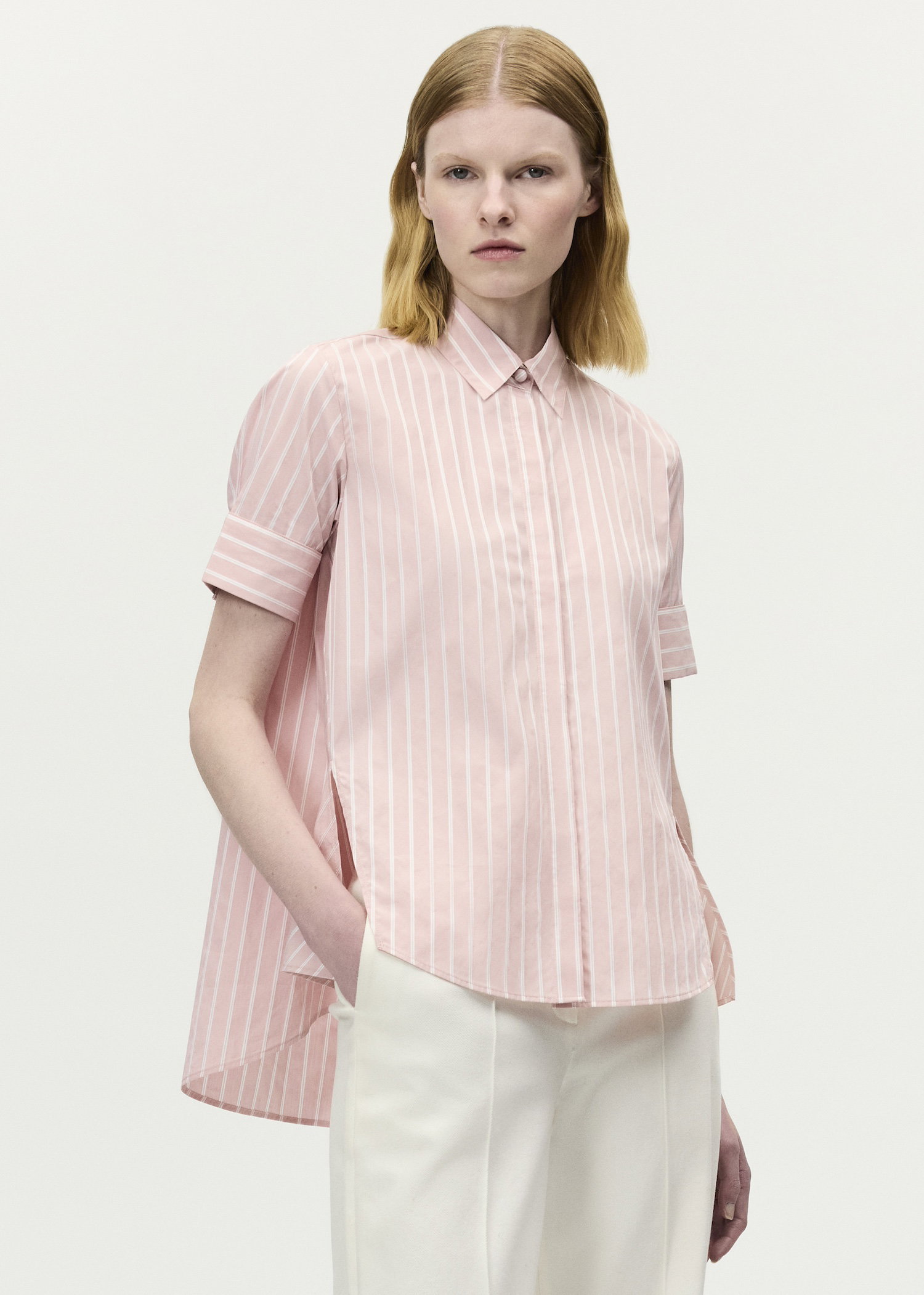 Image of a model wearing the Charlie top in pale pink and white stripes 