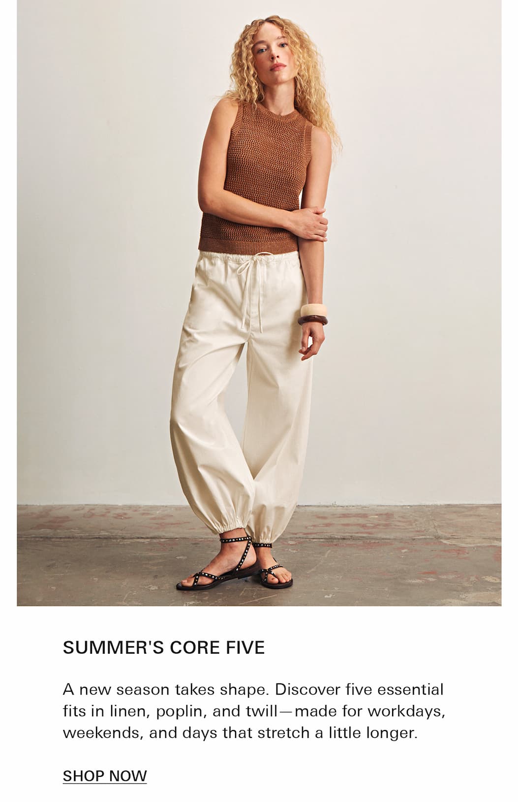 A woman with curly blonde hair wears a sleeveless brown knit top, loose white pants, and black sandals. She stands against a plain background with one hand on her waist. Text below promotes summer wardrobe essentials.