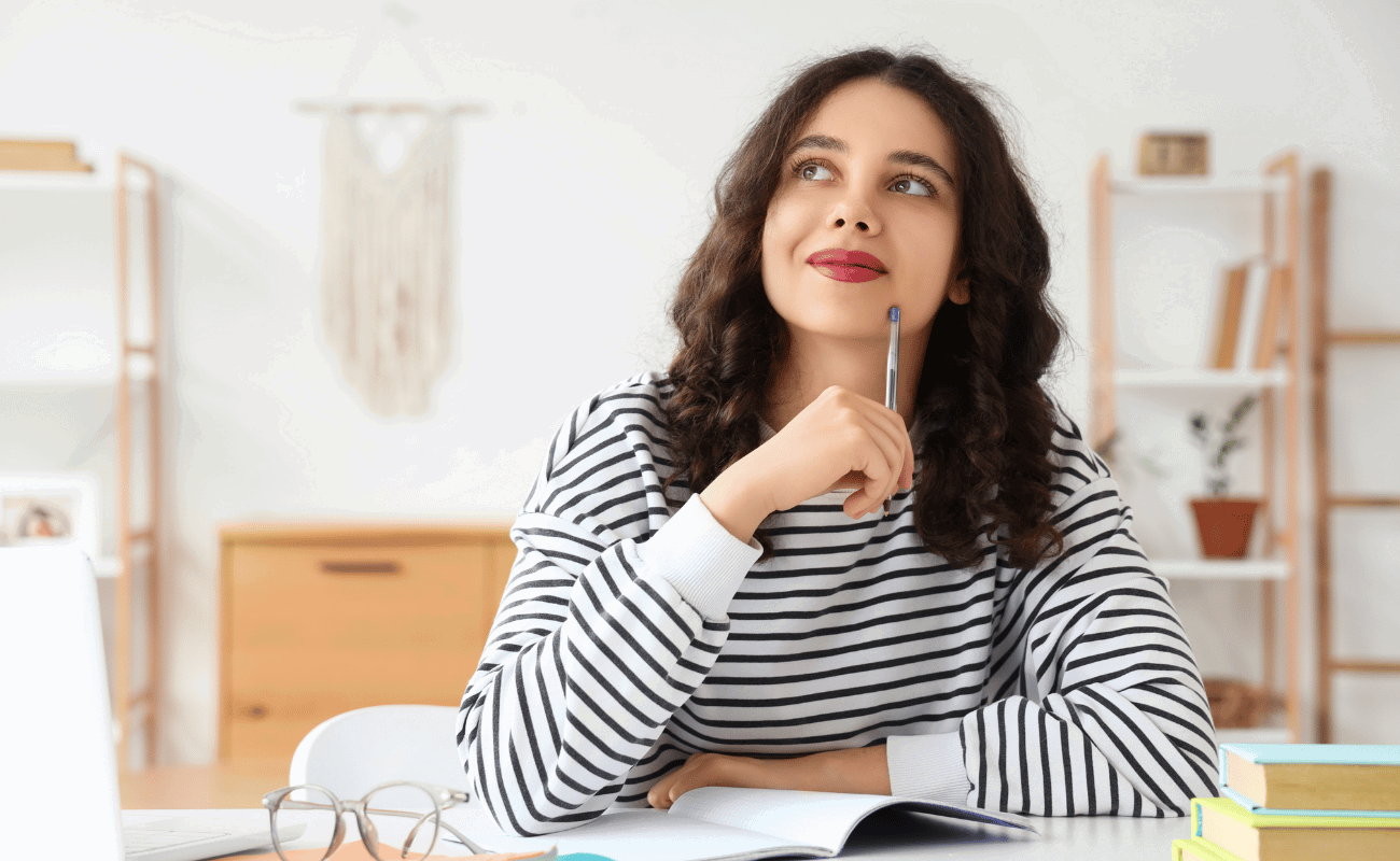 woman studying with pen and paper