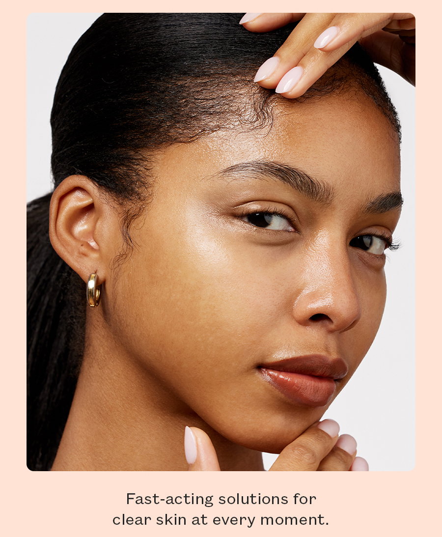 A woman looks directly into the camera with a fresh, dewy face.