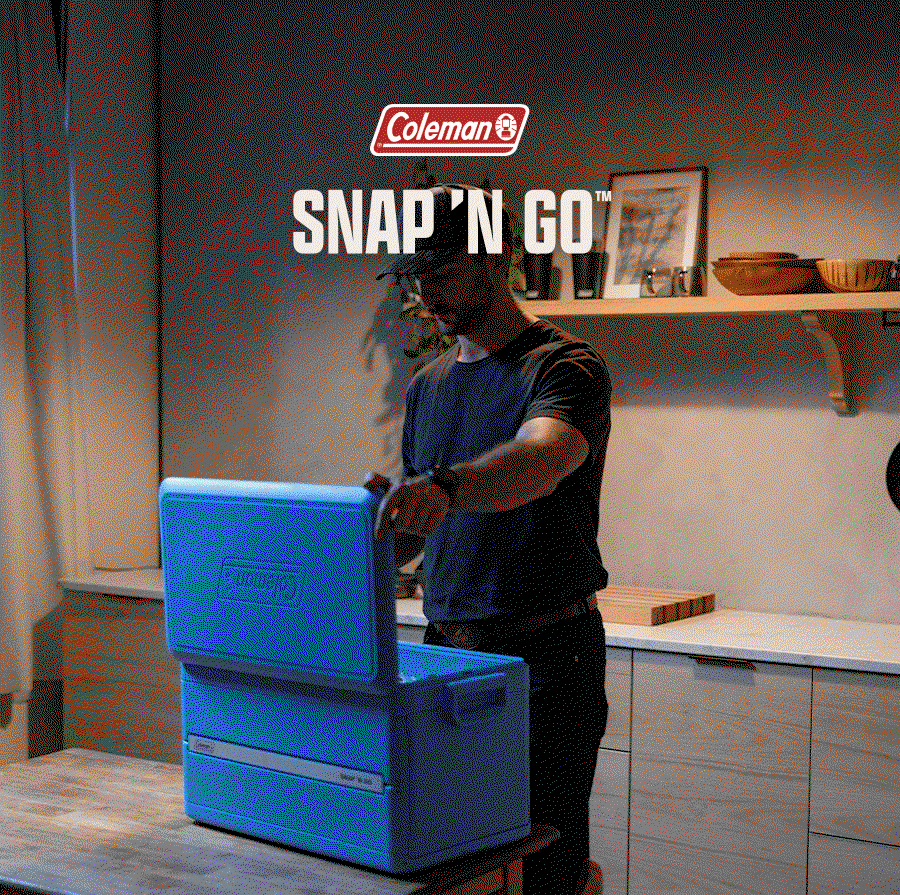 Man opening blue Coleman Snap 'N Go cooler in kitchen, Coleman logo and Snap 'N Go text above.