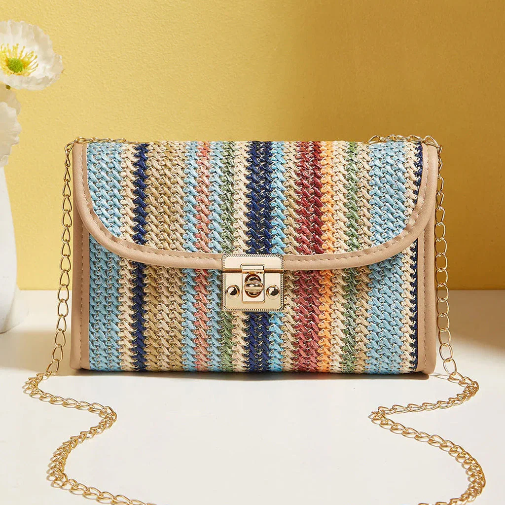 Colorful striped woven crossbody bag with tan leather trim and gold chain strap on yellow background