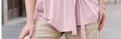Ein Model trägt ein rosé farbenes Shirt mit Bindebändern. Daneben folgender Text: Shirts so vielseitig wie du
