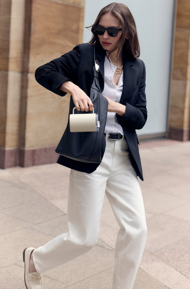 Woman wearing Tie Belted Blazer with Linen in Midnight Navy and Tie Belted Blazer with Linen in Ecru
