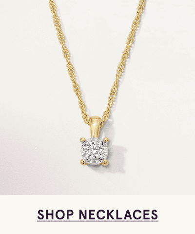 A gold necklace with a round diamond pendant. Click here to shop necklaces