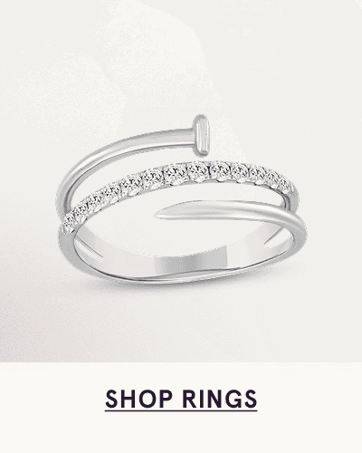 A white metal multi diamond ring with a spiral nail design. Click here to shop rings