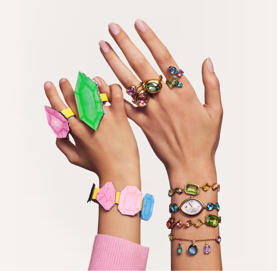 Hand models wearing multiple Swarovski bracelets