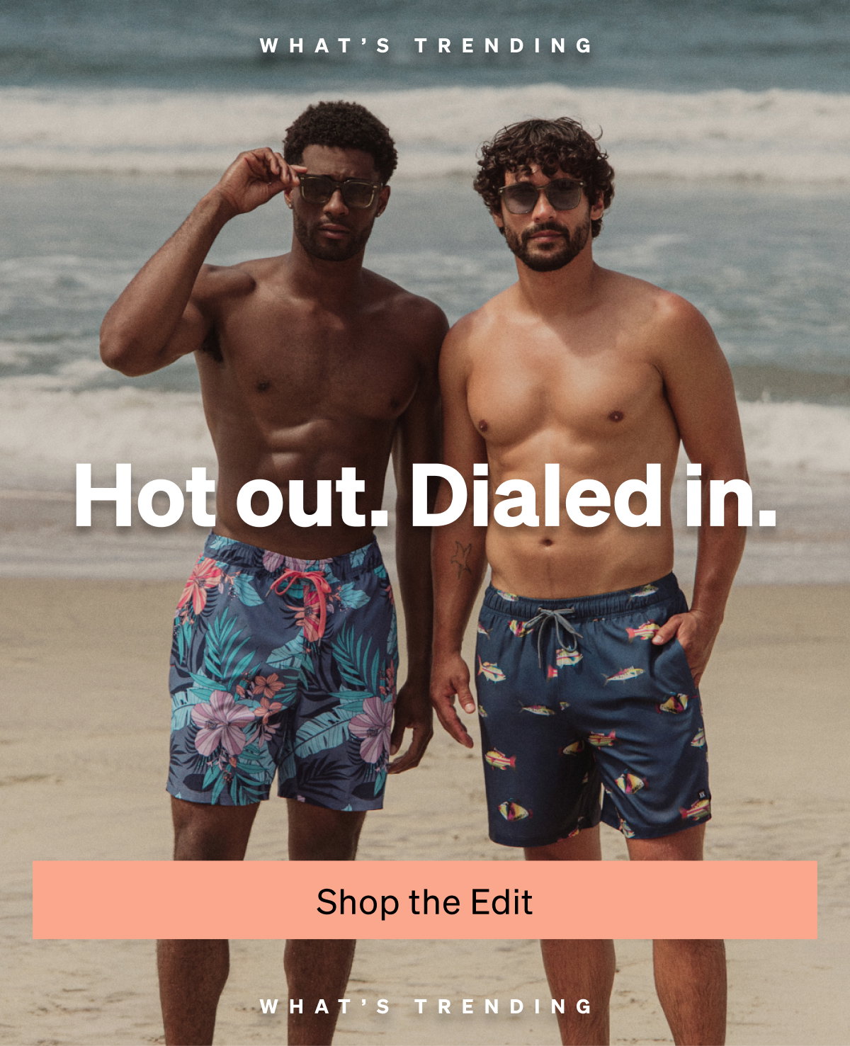 Two men wearing patterned swim shorts standing on the beach with “Hot out. Dialed in.” text overlay.