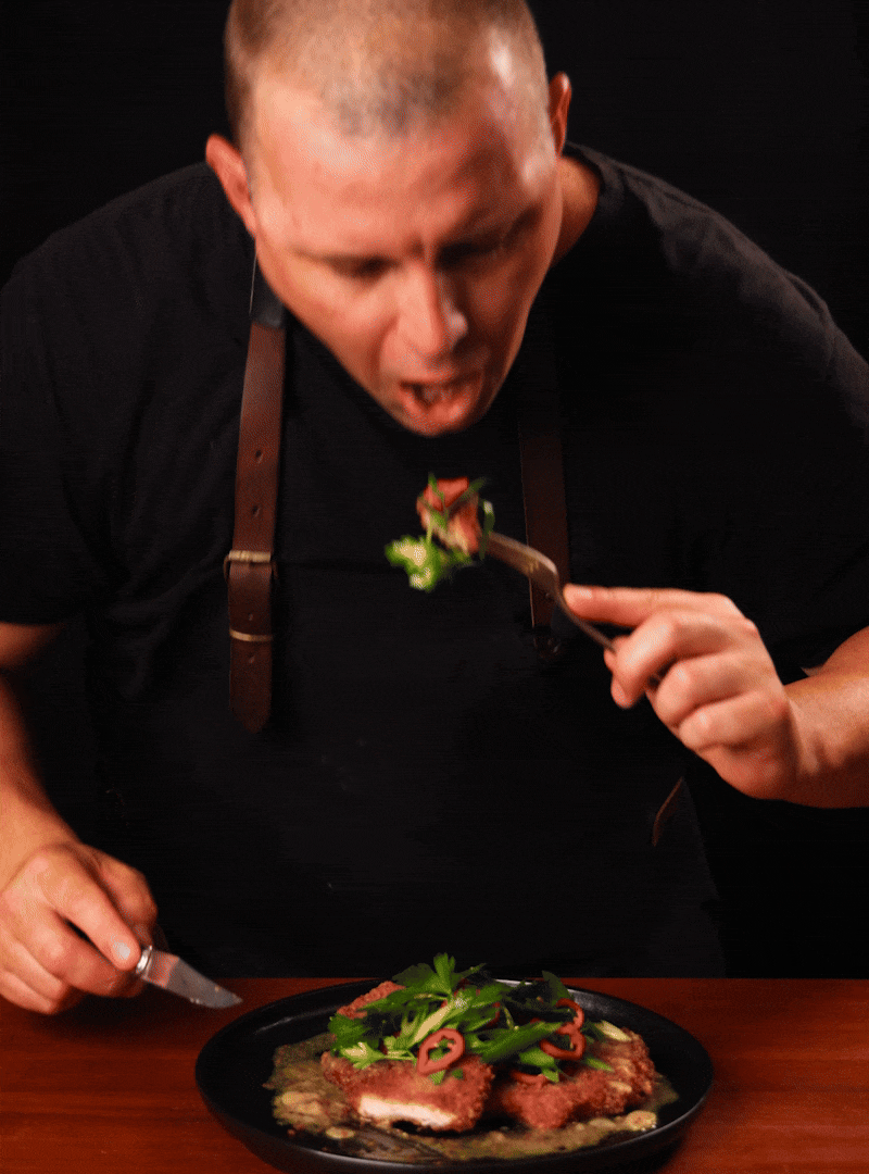GIF: Chad Montano eating pork chop, dancing, then showing Hestan ProBond Luxe skillet