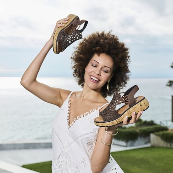 Women holding summer sandals