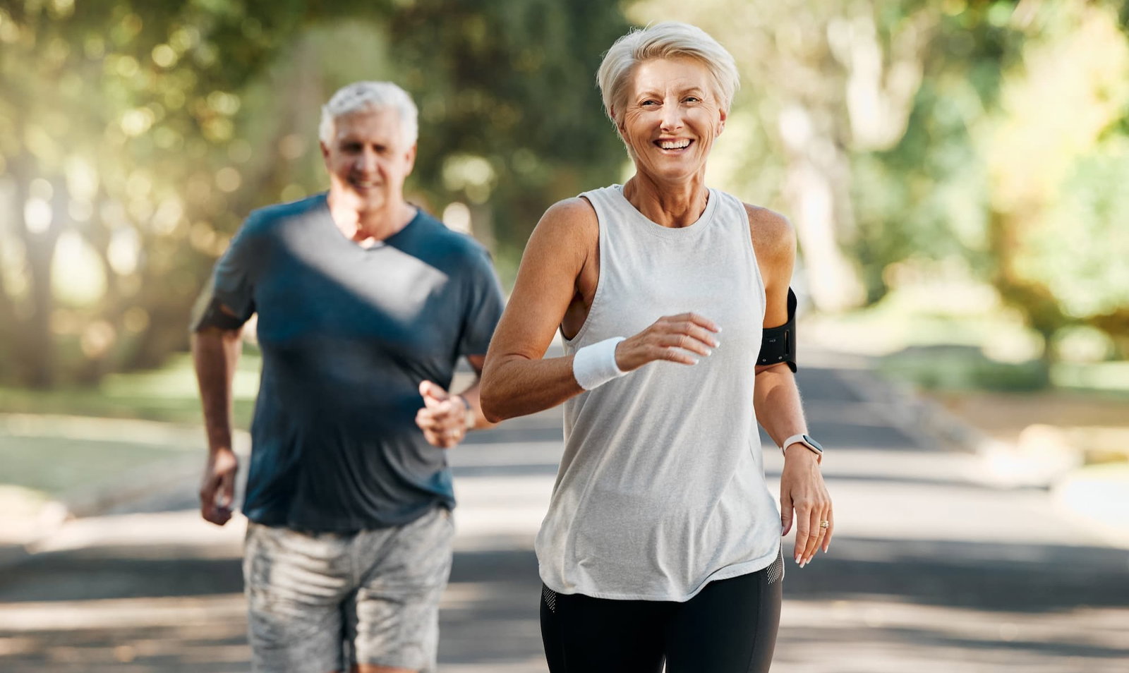 Smiling couple running outside