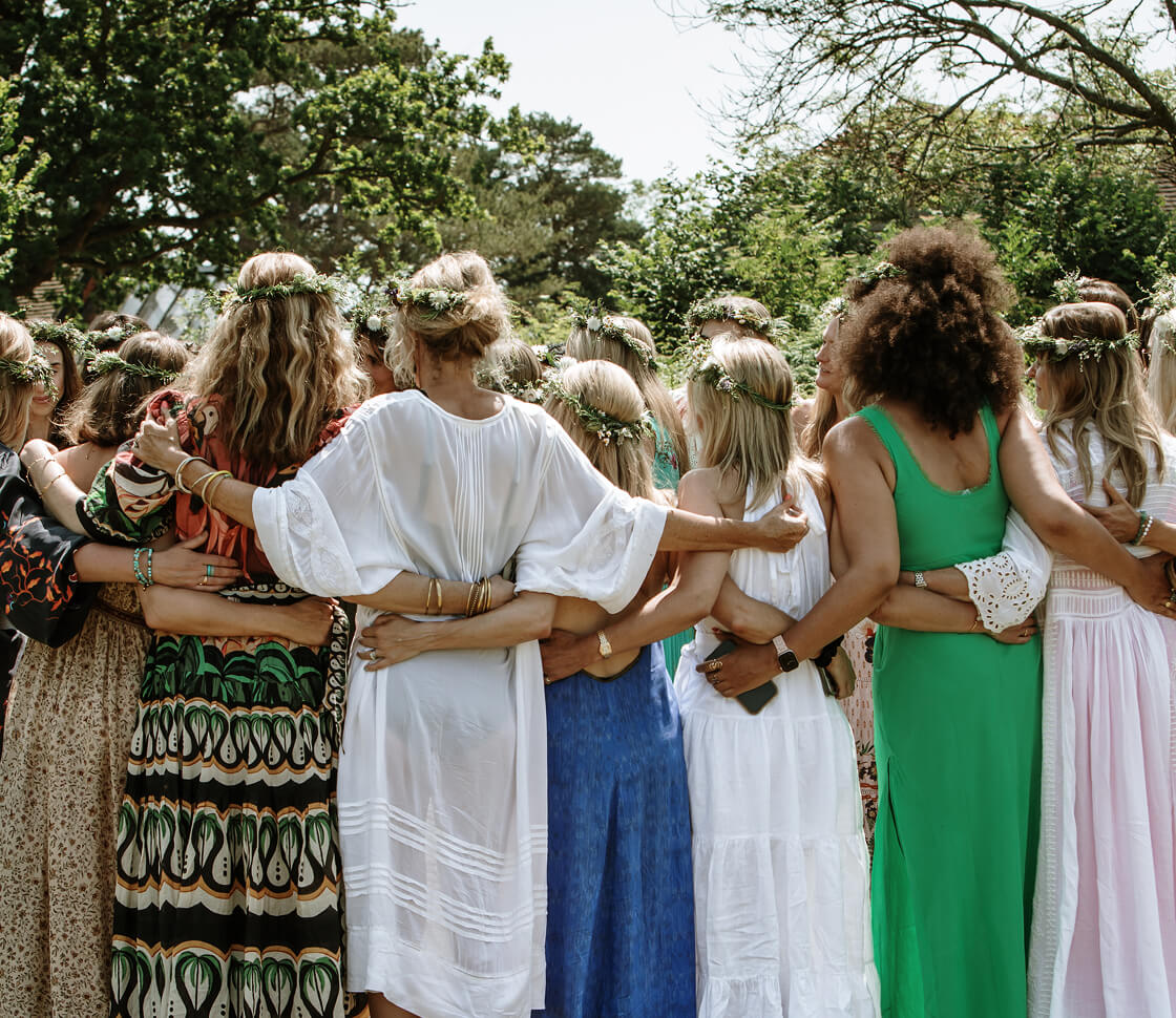 Woman gathered together in a hug.