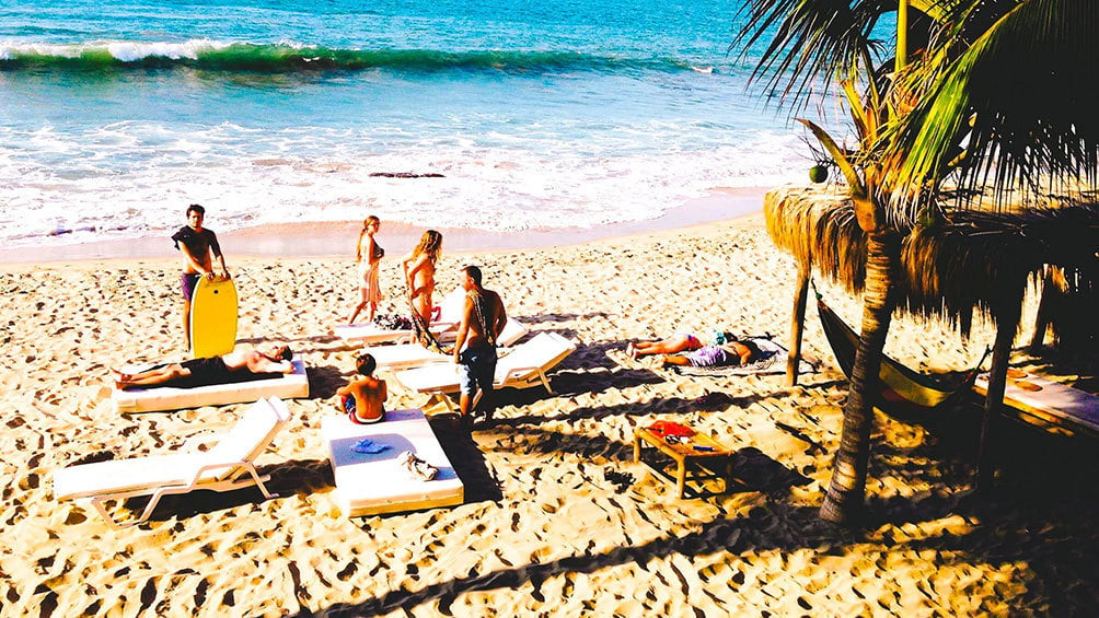 Image Description: Group of friends on Las Pocitas Beach, Mancora, Peru.