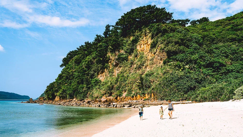 Image Description: Family walking on tropical beach, Iriomote, Okinawa, Japan.