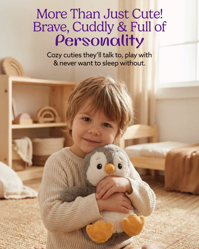 A little boy hugging Cozy Cute Penguin. Shop Now.