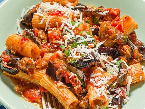 A serving of pasta alla norma on a plate.