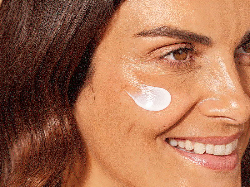 An animated sequence of three close-up shots, each featuring a different person smiling while a dab of white SPF cream is applied to their cheek.