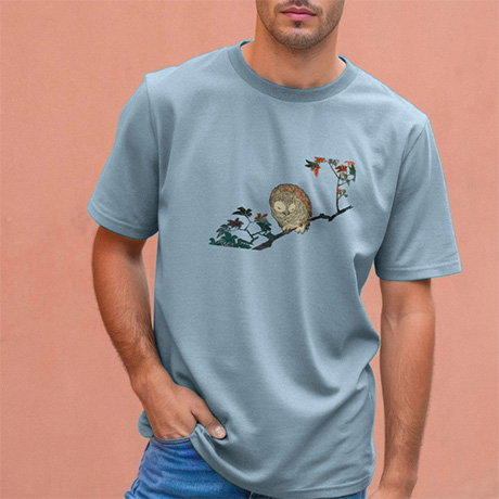 Stone-blue T-shirt featuring a serene illustration of a sleeping horned owl by Utagawa Hiroshige, worn by a model. - Shop Fashion.