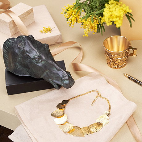 Bronze horse ornament, gold-plated necklace and Greek Vapheio Cups replica on a beige background with decorative ribbon and flowers. - Shop Gifts.