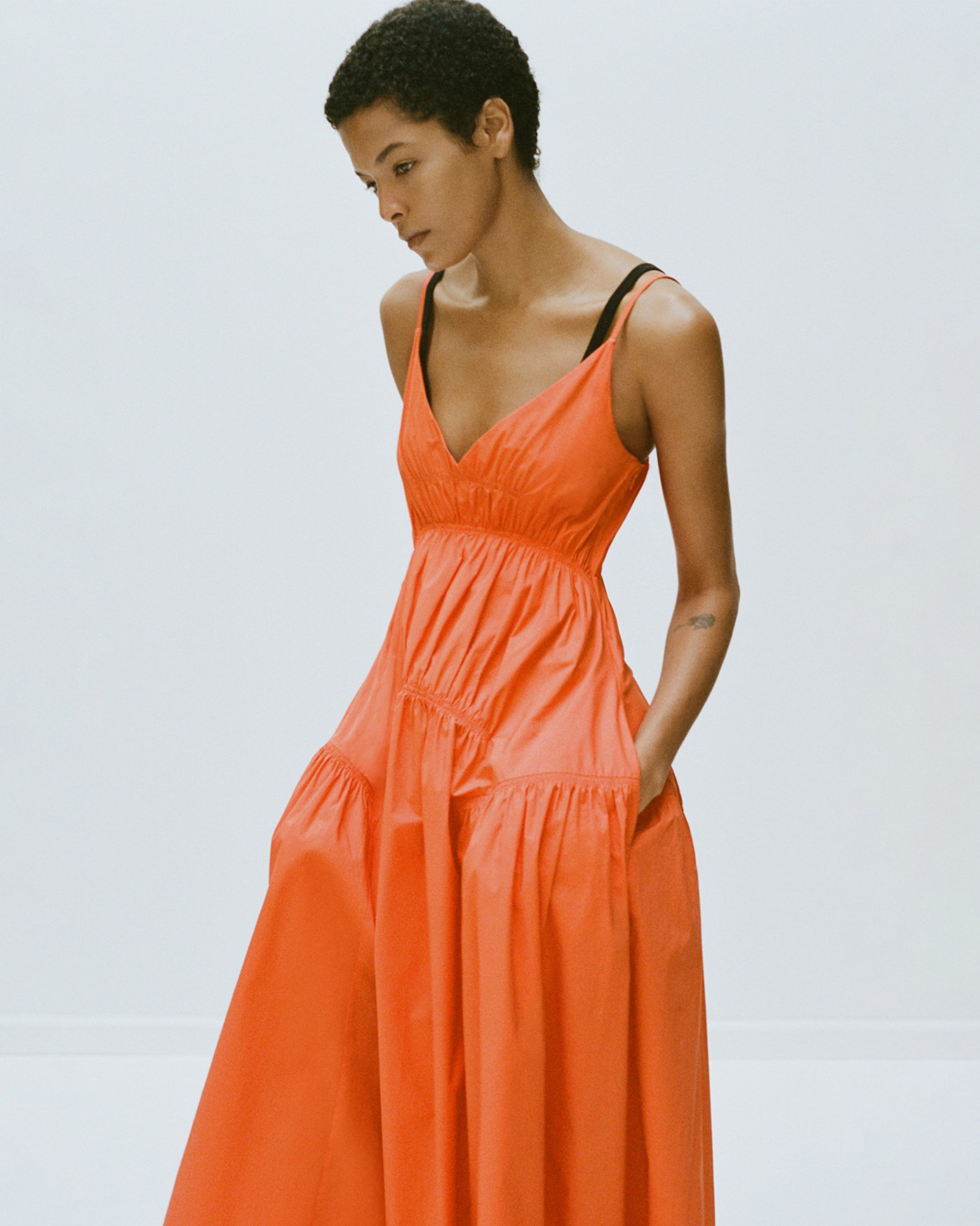 Model standing against white background wearing Michelyn Dress in Poplin in Orange