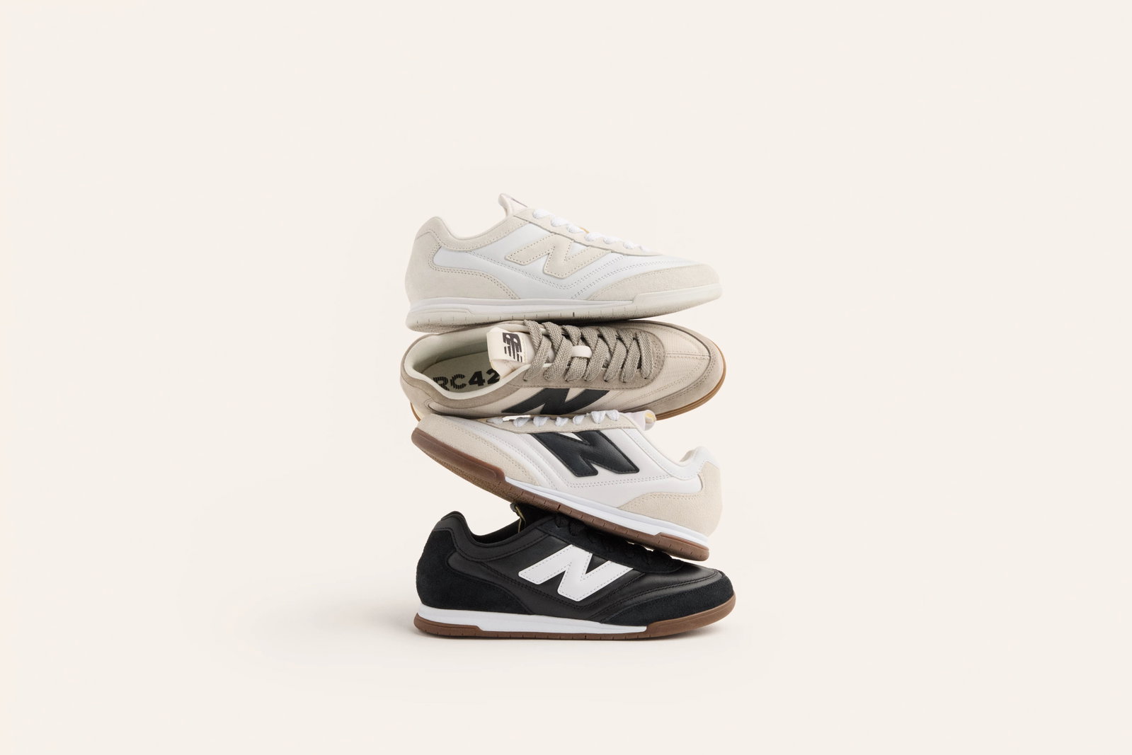 Multiple pairs of New Balance RC42 shoes stacked on top of one another