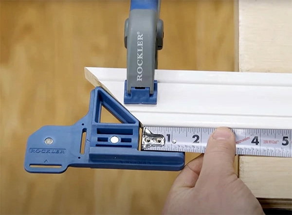 Measuring a piece of molding with a clamped tool