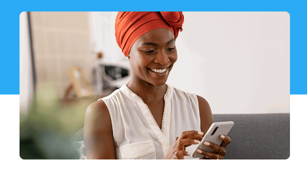 A women smiling at her phone 