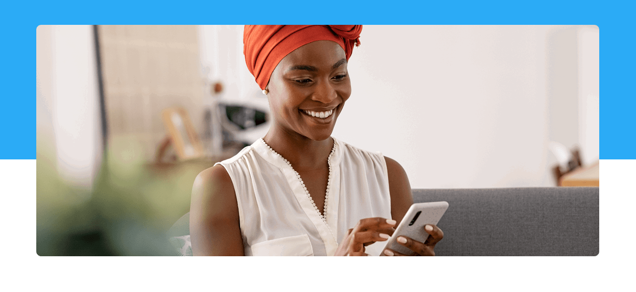 A women smiling at her phone 