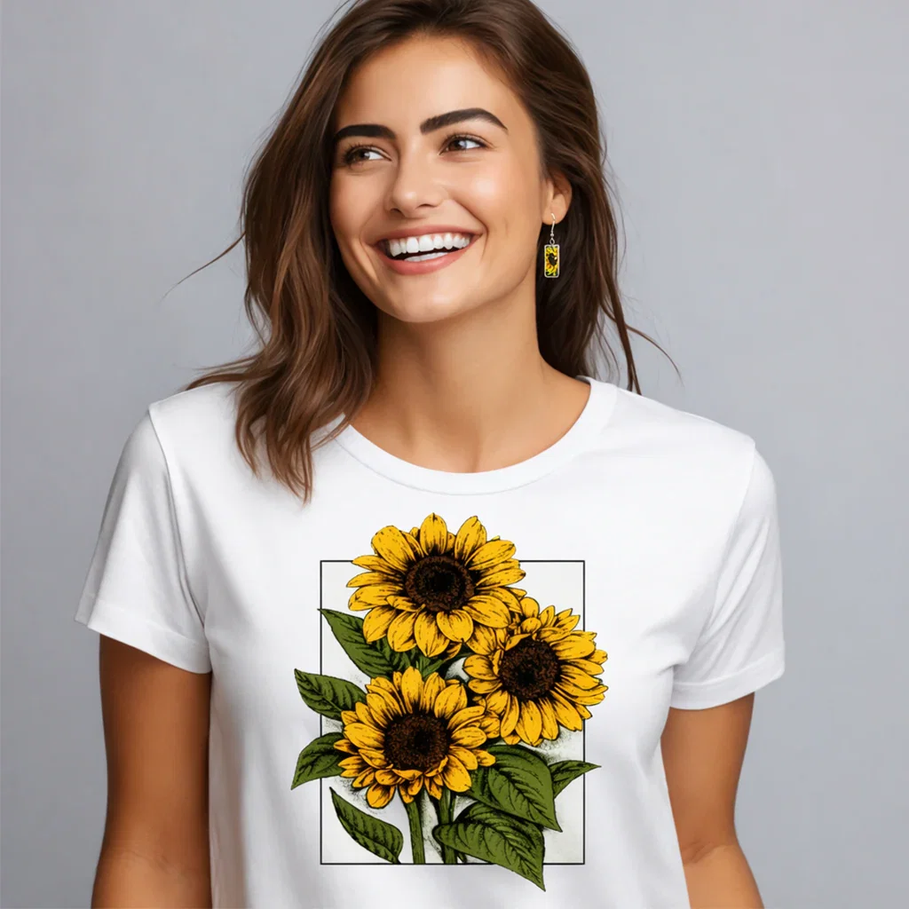 Woman wearing white t-shirt with yellow sunflower print design against gray background