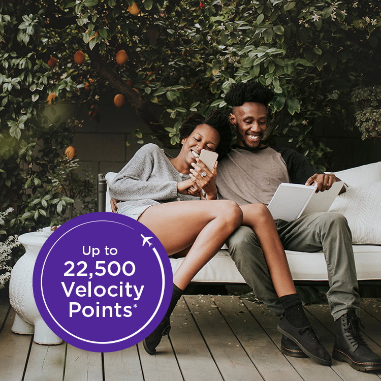Couple on phone. Text overlay: Up to 22,500 Velocity Points.