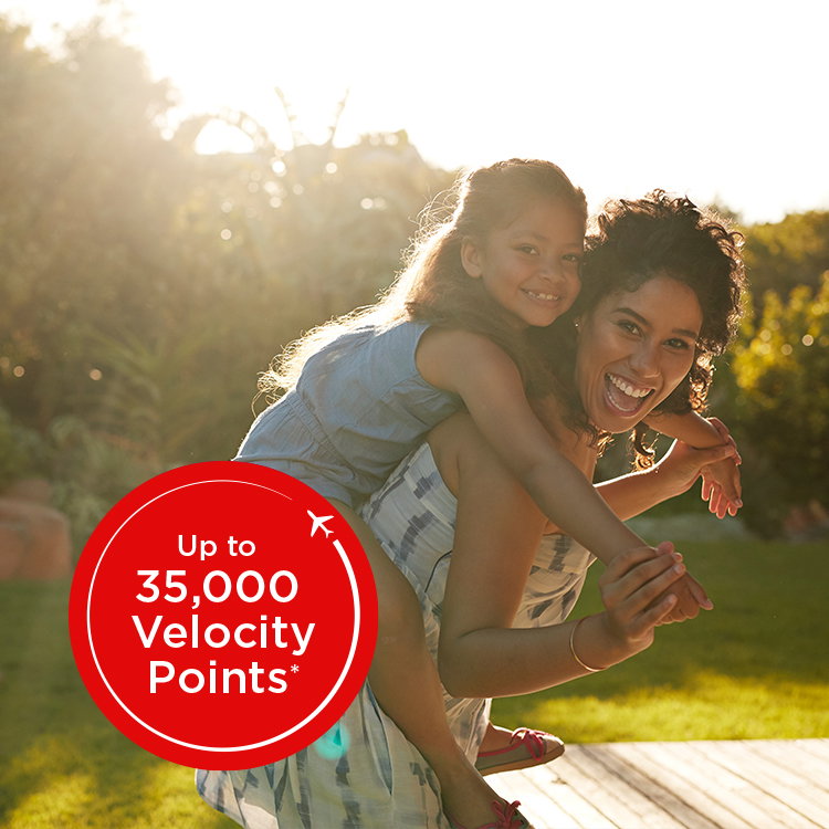 Woman giving piggy back ride. Text overlay: Up to 35,000 Velocity Points.