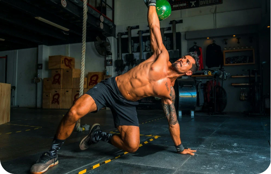 man lifting kettlebell in the gym