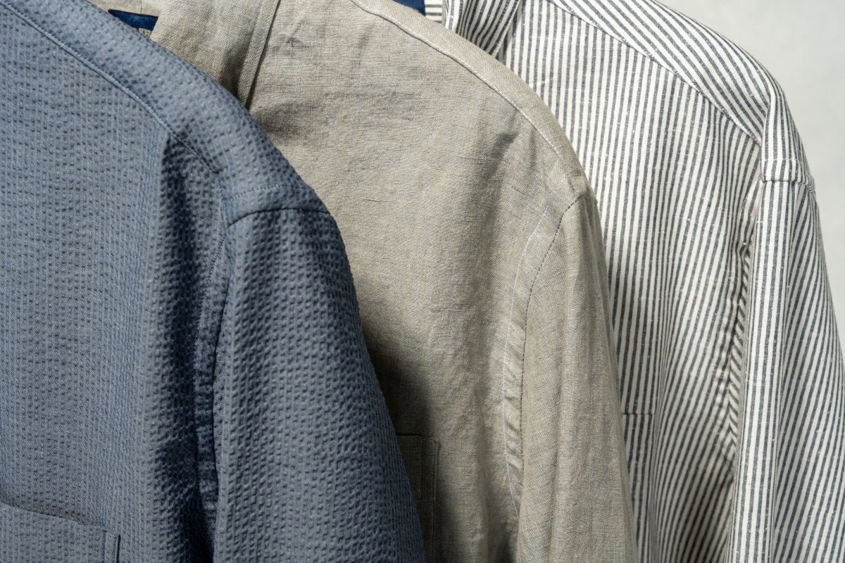 Close up of three Bills Khakis Gitman shirting shoulders in three colorways