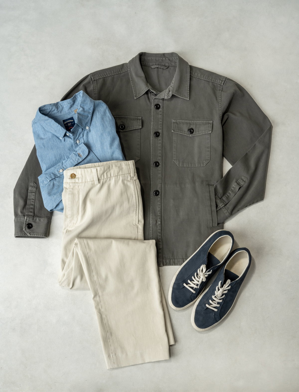 A full outfit of Bills Khakis spring wear - a olive over shirt, a blue gitman shirting, a pair of 5 pocket khakis, and pair of sneakers