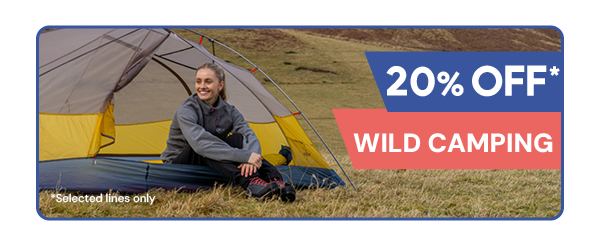 20% OFF* WILD CAMPING. A smiling woman sits in the doorway of a Phoxx 1 Ultralite Tent. 