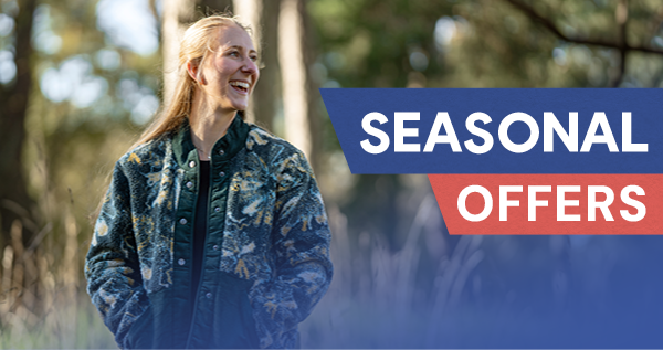 SEASONAL OFFERS: A laughing woman wearing Passenger Women's Clover Recycled Cotton-Lined Sherpa Fleece in Green.