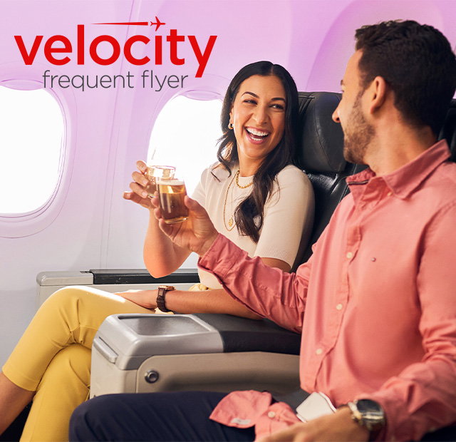 Couple enjoying business class seats.