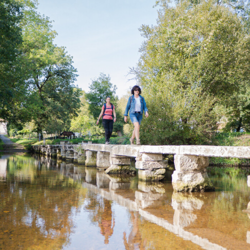 Walkers crossing a river in Charente
