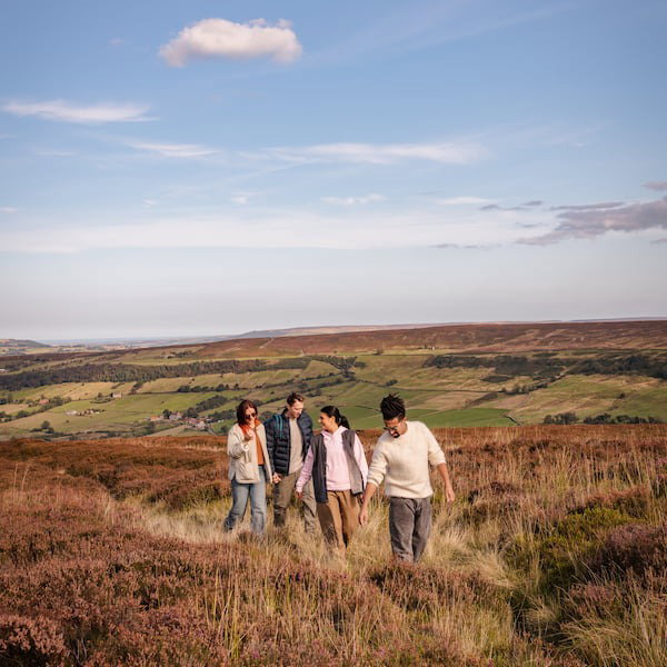 A group of friends walking through the North York Moors Countryside
