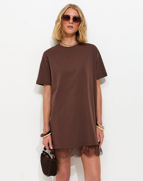 Pair of brown strappy heeled sandals with square toe and ankle straps, featuring a mid block heel on a neutral background.