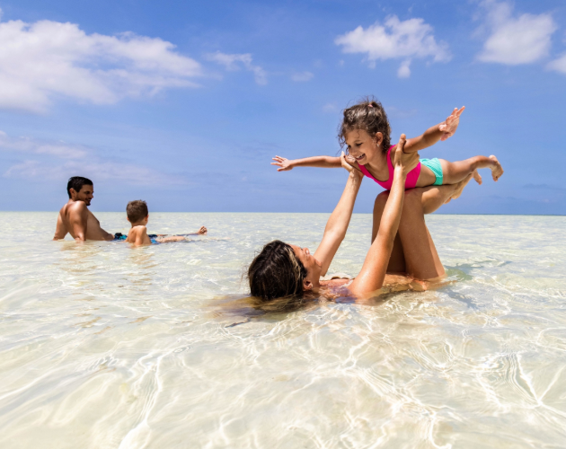A family playing in the water at the beach