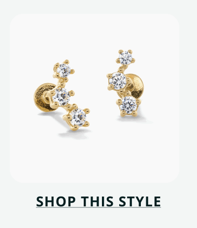 Gold cluster studs with three round-cut stones of varying sizes in triangular grouping. Click here to shop this style