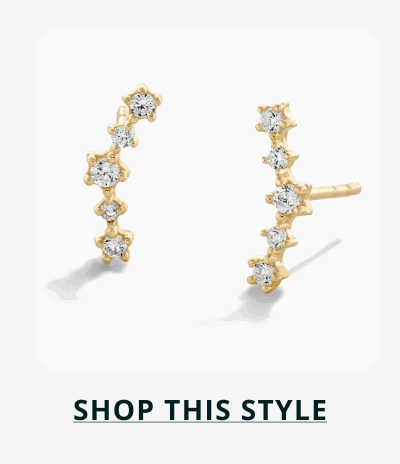 Curved gold climbing studs with five round stones that follow contour of ear. Click here to shop this style