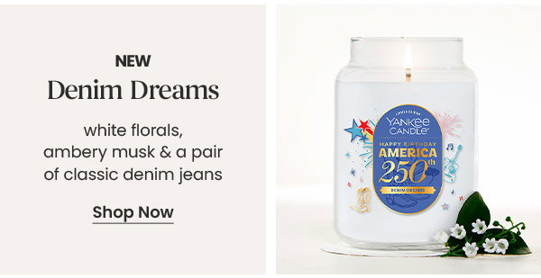 New denim dreams scent with description white florals, ambery musk and denim jeans. Shop Now button displayed. Candle jar visible.