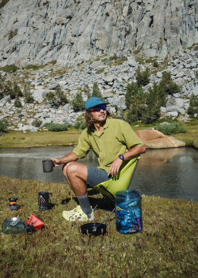 A camper wearing the Men's Cottonwood™ Camp Lite Shirt